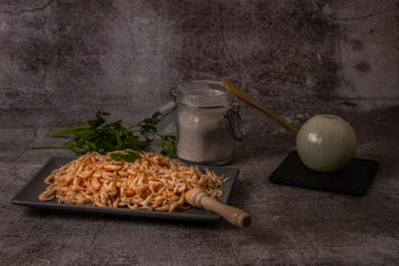 fresh shrimps in a ceramic tray with parsley, flour and onionの写真素材
