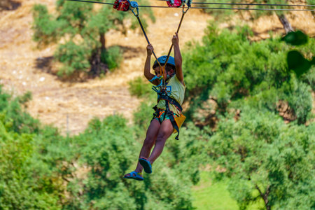 zahara de la sierra ,cadiz ,spain july 8th, 2022 close-up of a child having fun jumping on a zip...