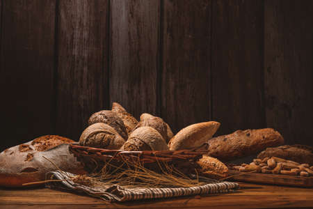various types of artisan breads made with sourdough from wheat ears and put in a wicker basket