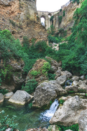 views from the river of the new bridge of Ronda over the cliff .Andalusia, Spainの写真素材