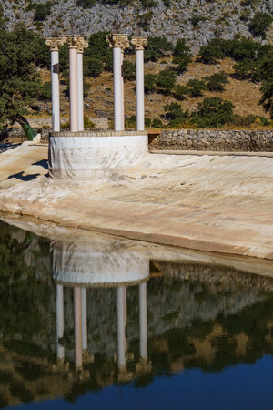 set of columns reflected in a mountain landscape lakeの写真素材