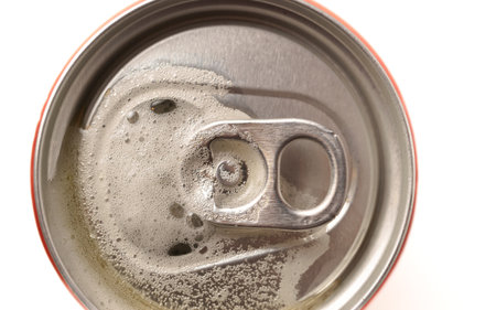 top view of an out-of-focus beer can on a white background