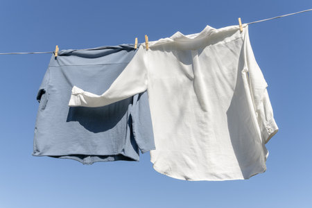 shirts lying in the sun, blue sky in the backgroundの写真素材