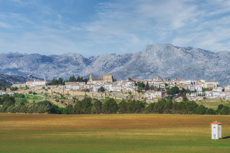 panoramic view of the city of ronda, andalucia, spain with huge mountains in the background and...