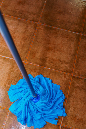 top view of a blue mop mopping the floorの写真素材