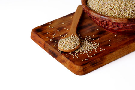 wooden spoon with quinoa and wooden bowl full of seeds isolated on white background and copy spaceの写真素材