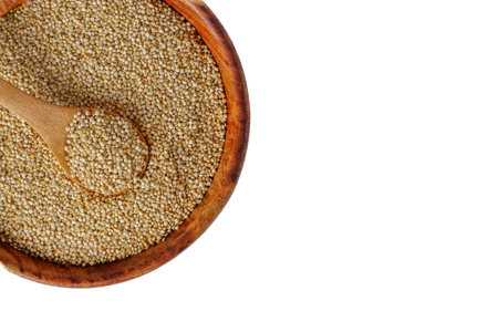 wooden spoon with quinoa superfood on a wooden bowl with raw seeds isolated on white background and copy spaceの写真素材