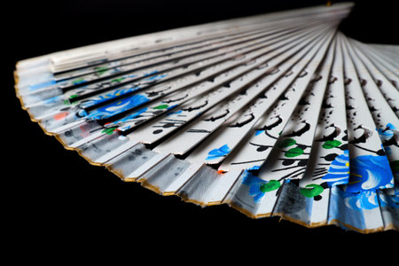 hand painted white fan isolated on black backgroundの写真素材