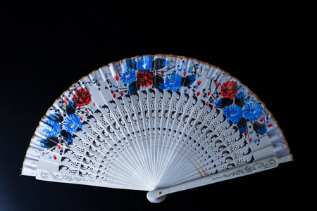 hand painted white fan isolated on black backgroundの写真素材