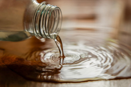 close-up shot of a plastic water bottle spilling water on the groundの写真素材