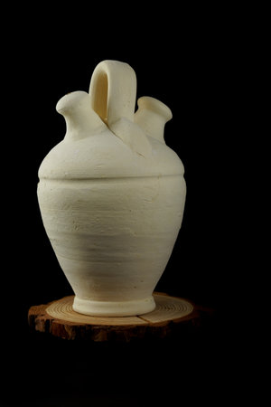 handmade clay botijo isolated on black backgroundの写真素材