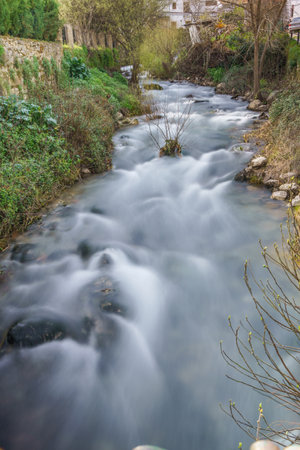 waterfall of a mountain river with silk water effectの写真素材