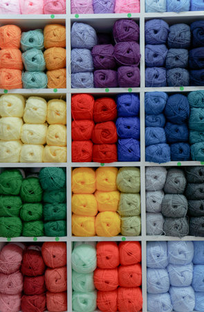 Colorful yarn and wool balls on display in a craft storeの写真素材