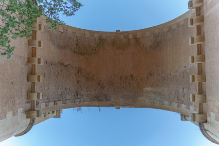 stone bridge seen from below with blue sky in the backgroundの写真素材