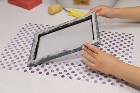 close-up of a child's hands making recycled paper at homeの写真素材