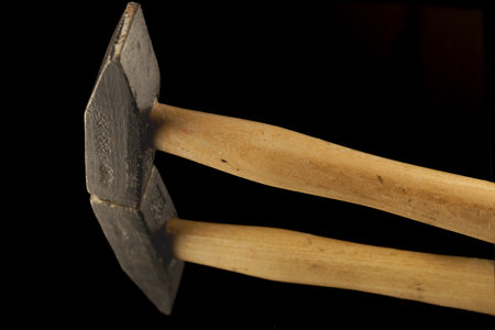 close-up of a hammer reflected in a mirror isolated on a black background with copy spaceの写真素材