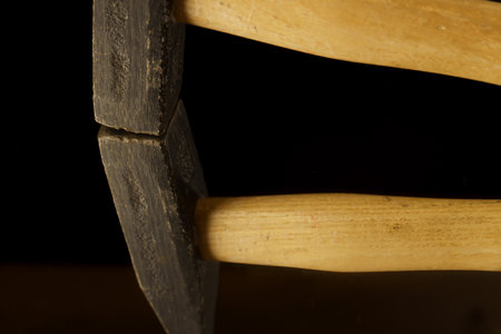 close-up of a hammer reflected in a mirror isolated on a black background with copy spaceの写真素材