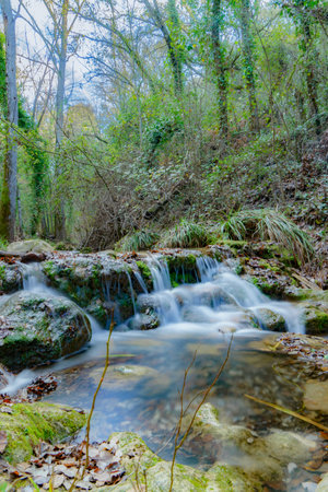 waterfall in a crystal clear river silk effect long exposure photographyの写真素材