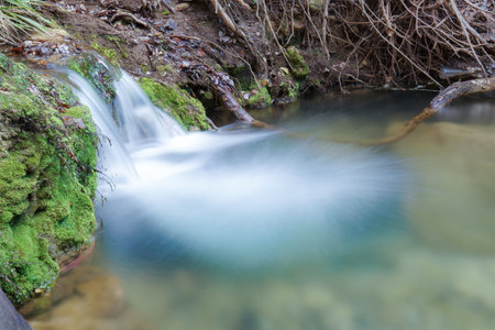 close-up of a waterfall of crystal clear water, long exposure silk effect photographyの写真素材