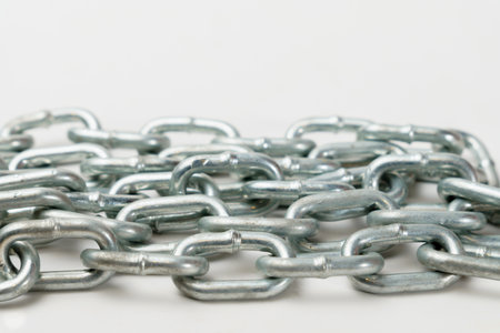 close-up of a metal chain with space for text and white background