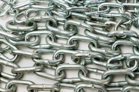 close-up of a metal chain with space for text and white backgroundの写真素材