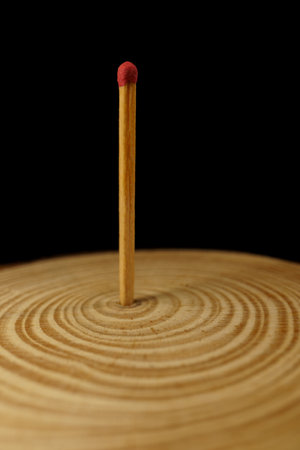 close-up of an extinguished match isolated on black background with copy spaceの写真素材