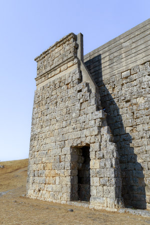 08/21/2025 Ronda, Malaga, Spain Partial view of the ruins of the Roman amphitheater of Acinipo with a blue sky in the backgroundの写真素材