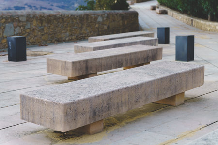 Minimalist concrete benches defining an urban park pathway, offering modern seating and a serene outdoor environmentの写真素材
