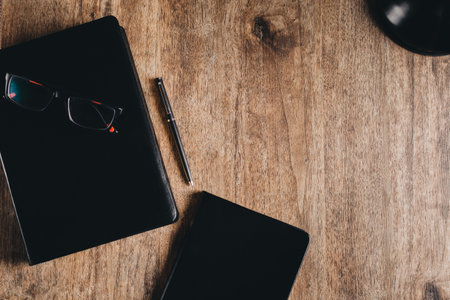 Bible and notebook on a wooden desk.の写真素材