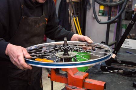 man repairing a bike in his workshopの写真素材