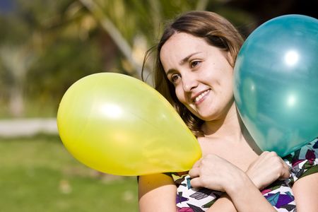 Beautiful woman with balloons in her handsの写真素材