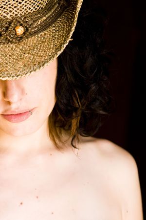 Young curly  woman with hat.