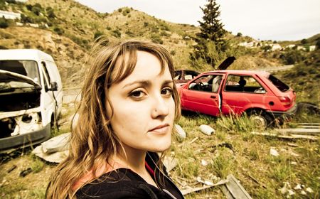 Young woman in the scrapyardの写真素材