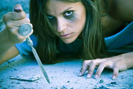 Violent dark woman armed with a knifeの写真素材