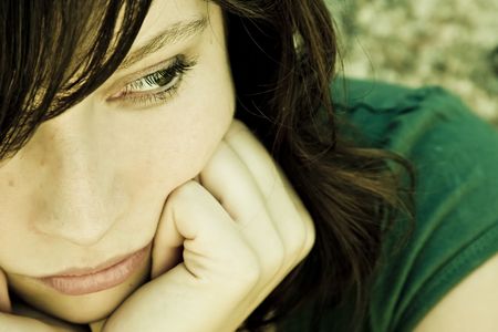Thoughtful young woman with pensive gesture.