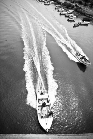Two boats cruising the river at high speed.の写真素材