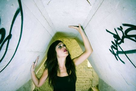 Terrified young woman inside of dirty place.の写真素材