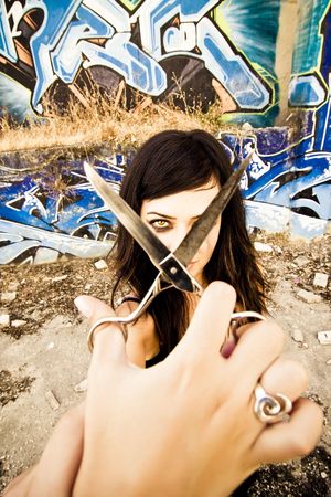 Young goth styled woman holding scissors for...の写真素材