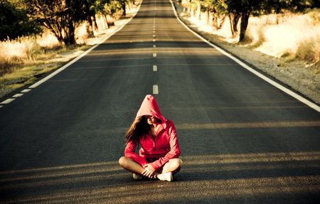 Unrecognizable mystery woman in the middle of the road.の写真素材