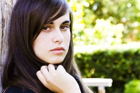 Young staring woman with green nature color as backgroundの写真素材