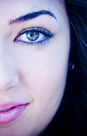 Half full woman portrait with amazing green eyes. Ice toned.の写真素材