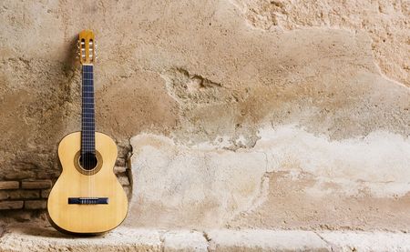 Spanish guitar on old wall, copy spaced.の写真素材