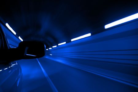 Driving fast inside tunnel, blue toned.の写真素材