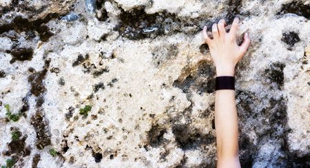 Young person hand holding a wall dramaticallyの写真素材