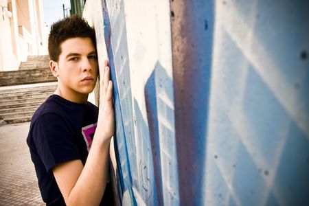 Young man portrait over grafted wall.の写真素材