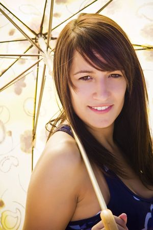 Young smiling woman under umbrella.の写真素材
