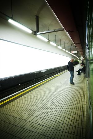 Empty underground station with blank advertisements.