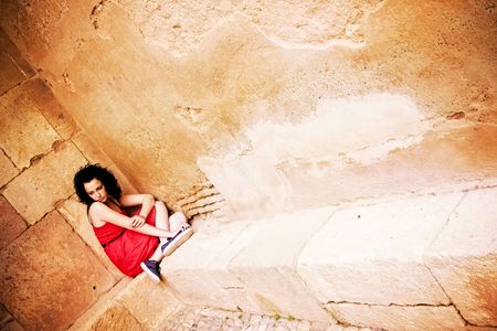 Sad young woman in a cornerの写真素材