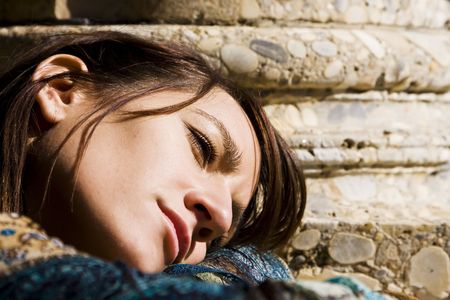 Young beautiful thoughtful woman in antique background.の写真素材