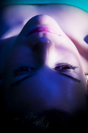 Thoughtful woman face in the shadowの写真素材